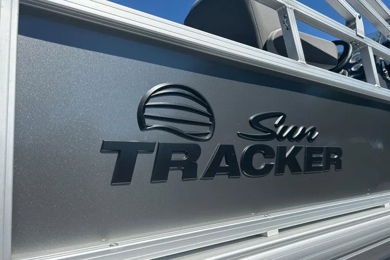 Slide: The Image of 2026 Sun Tracker Bass Buggy 18 DLX logo on sleek metallic surface. - 31