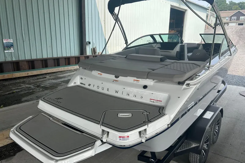 Slide: The Image of 2025 Four Winns H2 boat on trailer, featuring sleek design and spacious seating. - 3