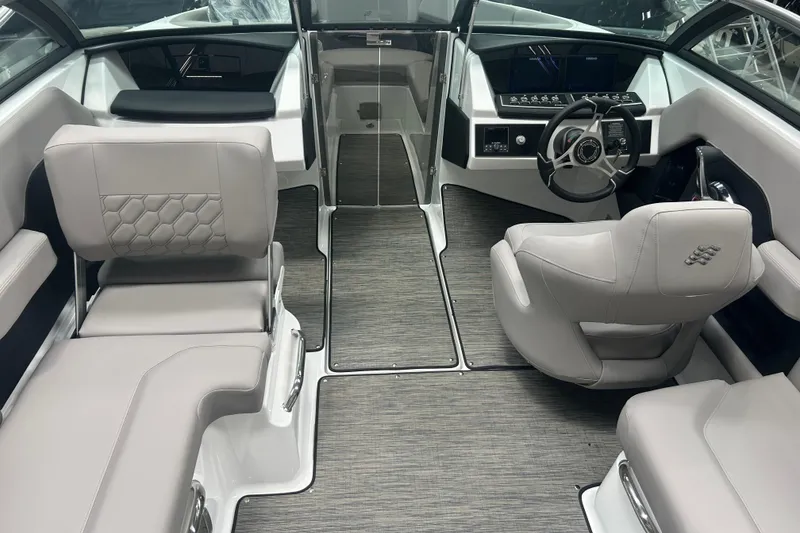 Slide: The Image of 2025 Four Winns H2 boat interior with modern seating and sleek dashboard design. - 9