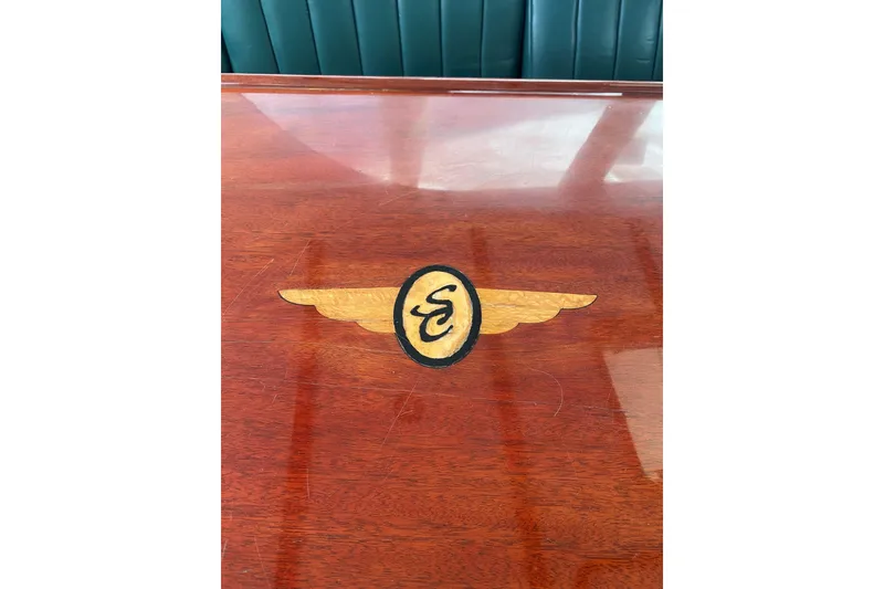 Slide: The Image of Mahogany Table with Santa Cruz Coastal Flyer engraved on bridge. - 10