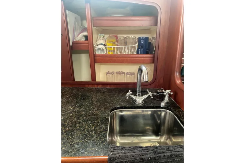 Slide: The Image of Santa Cruz Coastal Flyer 41 yacht kitchen with sink, faucet, and wooden cabinetry, 2001 model. - 11