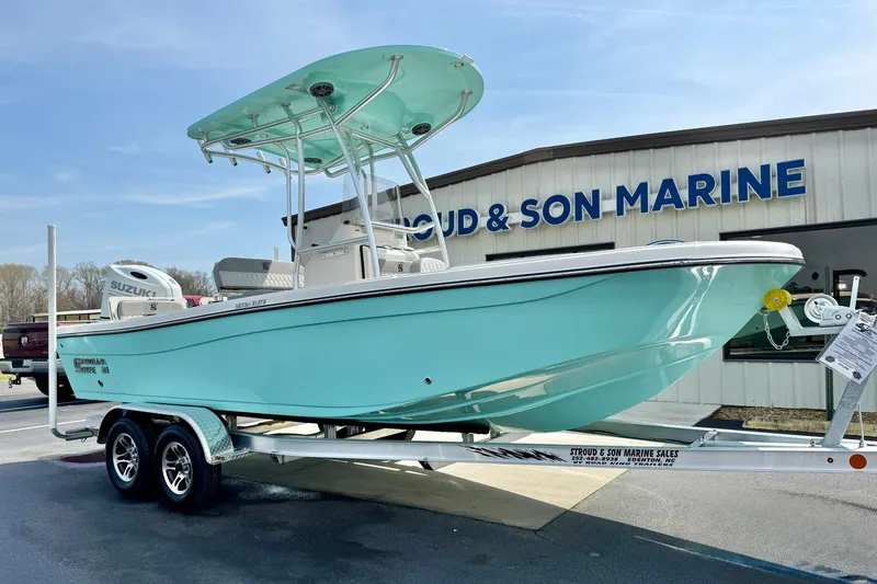 The Image of 2026 Carolina Skiff 21 Ultra Elite boat on trailer at marine dealership. - 1