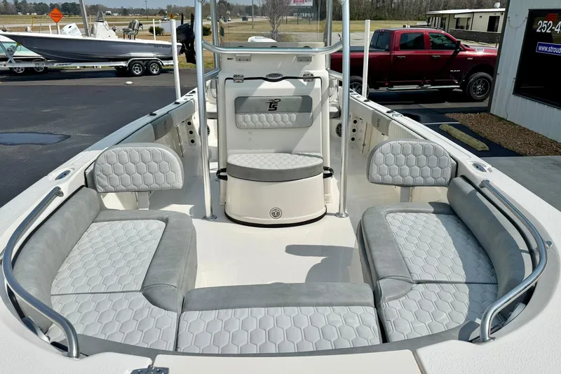 Slide: The Image of 2026 Carolina Skiff 21 Ultra Elite boat interior with gray cushioned seating and modern design. - 10