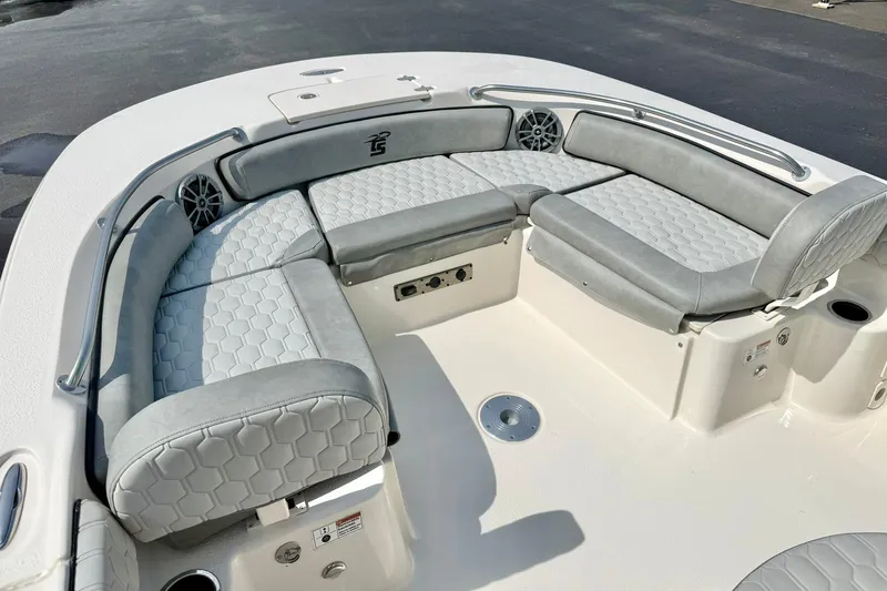 Slide: The Image of 2026 Carolina Skiff 21 Ultra Elite boat with gray cushioned seating and modern design. - 11