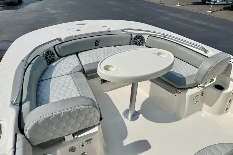 Slide: The Image of 2026 Carolina Skiff 21 Ultra Elite boat interior with cushioned seating and round table. - 12