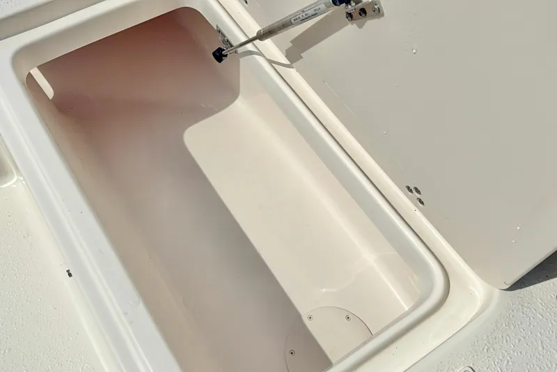 Slide: The Image of Storage compartment of 2026 Carolina Skiff 21 Ultra Elite boat, open and empty. - 16