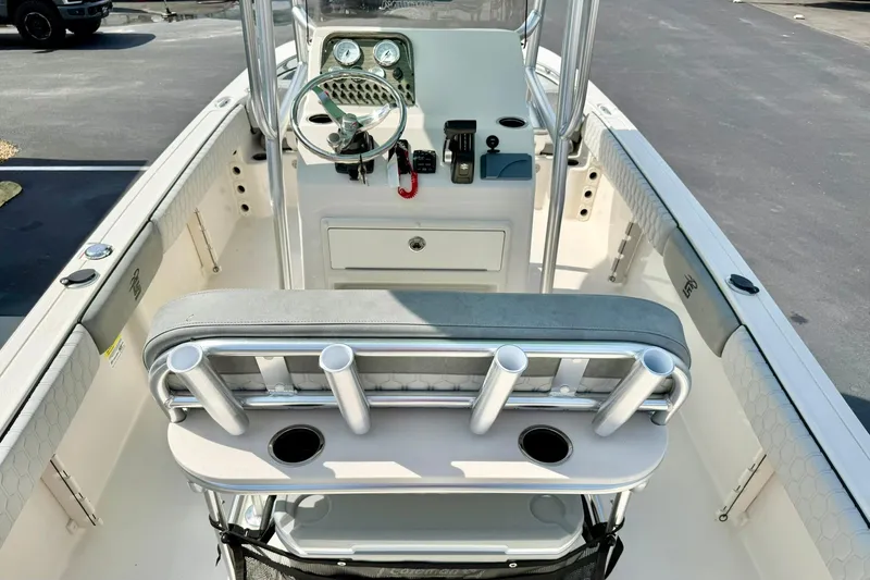 Slide: The Image of 2026 Carolina Skiff 21 Ultra Elite boat interior with steering console and rod holders. - 24