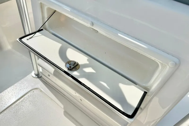 Slide: The Image of Open storage compartment on 2026 Carolina Skiff 21 Ultra Elite boat. - 26