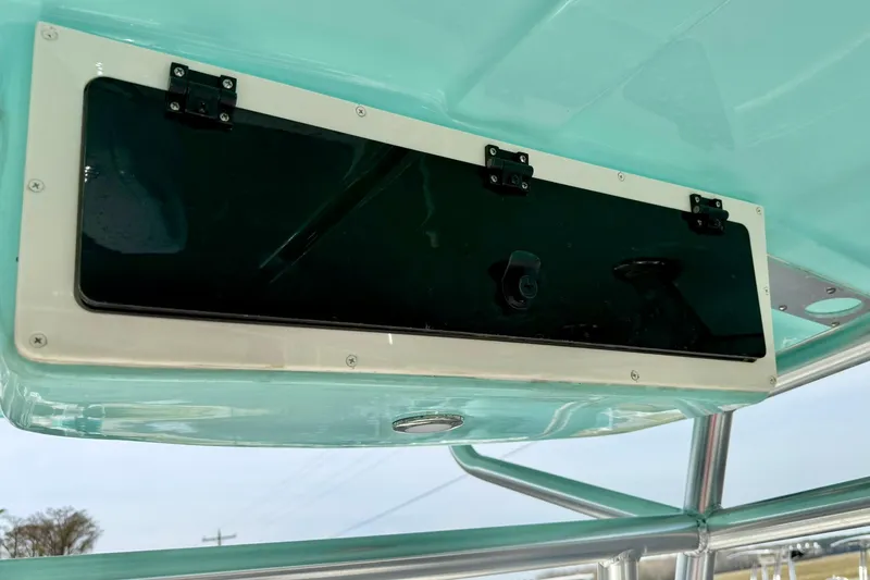 Slide: The Image of Storage compartment on 2026 Carolina Skiff 21 Ultra Elite boat, featuring sleek design and secure latches. - 27