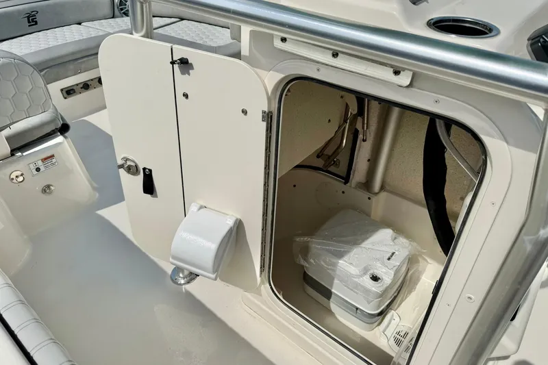 Slide: The Image of 2026 Carolina Skiff 21 Ultra Elite boat interior with storage compartment and seating. - 30