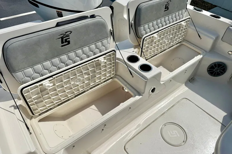 Slide: The Image of 2026 Carolina Skiff 21 Ultra Elite boat interior with storage compartments and cup holders. - 33