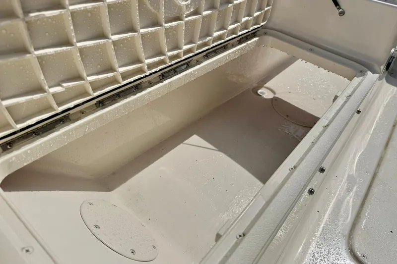 Slide: The Image of Storage compartment of 2026 Carolina Skiff 21 Ultra Elite boat, open and empty. - 34