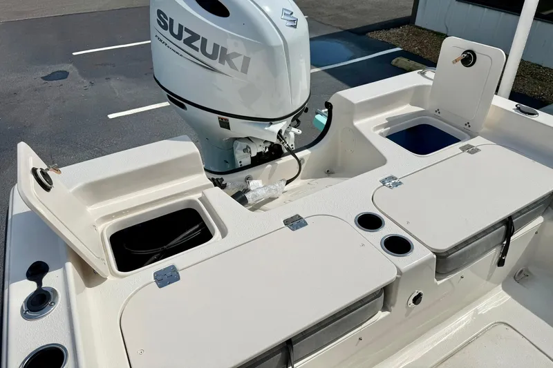 Slide: The Image of 2026 Carolina Skiff 21 Ultra Elite boat with Suzuki outboard motor and storage compartments. - 35