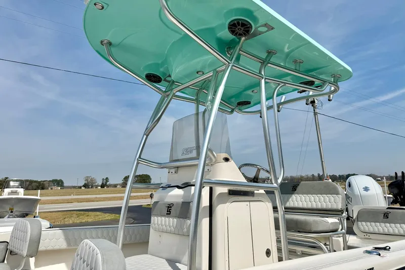 Slide: The Image of 2026 Carolina Skiff 21 Ultra Elite boat with teal canopy and modern seating. - 39