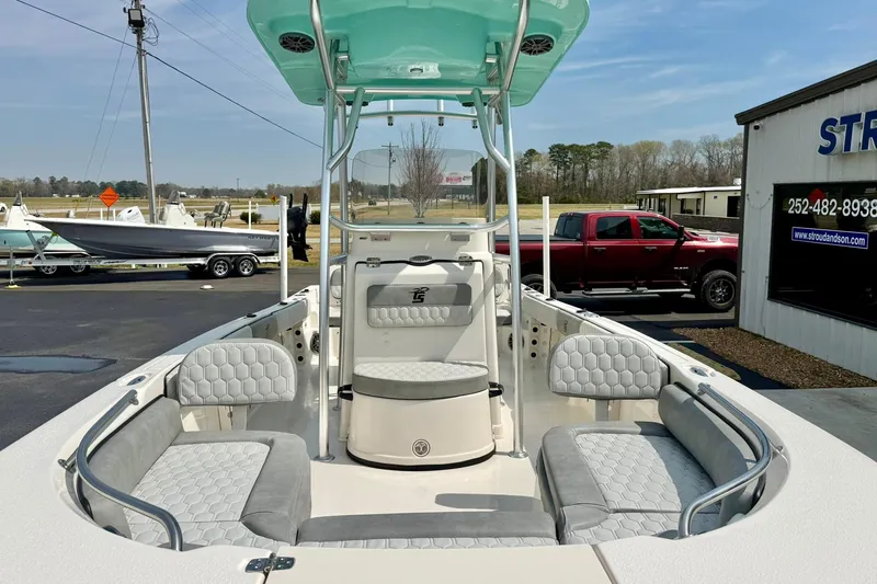 Slide: The Image of 2026 Carolina Skiff 21 Ultra Elite boat interior with seating and console, parked outdoors. - 40