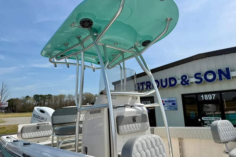 Slide: The Image of 2026 Carolina Skiff 21 Ultra Elite boat with T-top, parked near dealership. - 41