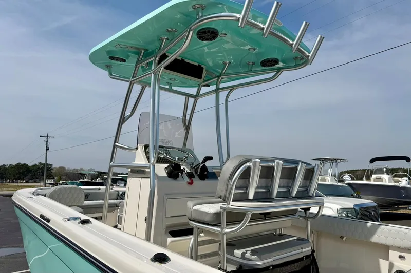 Slide: The Image of 2026 Carolina Skiff 21 Ultra Elite boat with T-top and seating, docked outdoors. - 43