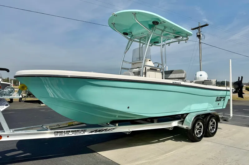 Slide: The Image of 2026 Carolina Skiff 21 Ultra Elite boat on trailer, light blue hull, outdoor display. - 5