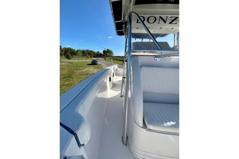 Slide: The Image of 2003 Donzi 32 ZF Open boat interior with white seating and sleek design. - 12
