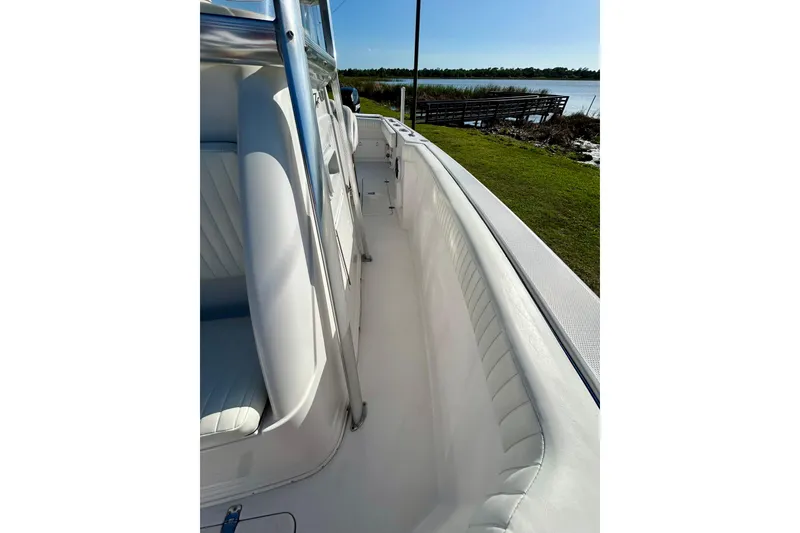Slide: The Image of 2003 Donzi 32 ZF Open boat interior with white seating and sleek design. - 13