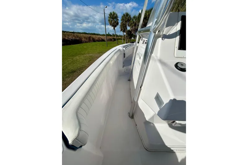 Slide: The Image of 2003 Donzi 32 ZF Open boat deck with clear skies and palm trees in the background. - 14