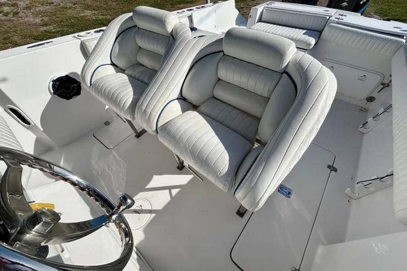 Slide: The Image of 2003 Donzi 32 ZF Open boat interior with white cushioned seats and steering wheel. - 18