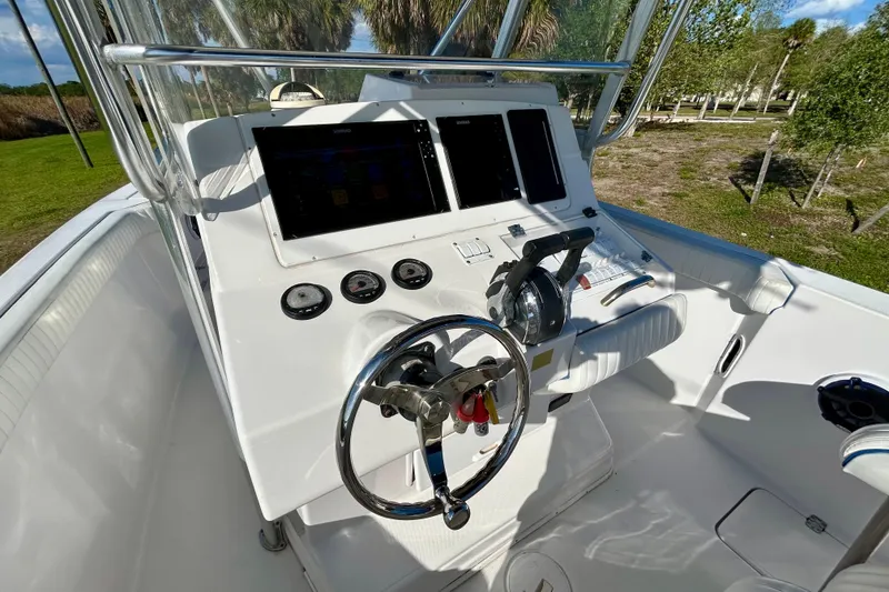 Slide: The Image of 2003 Donzi 32 ZF Open boat cockpit with steering wheel and control panel. - 21