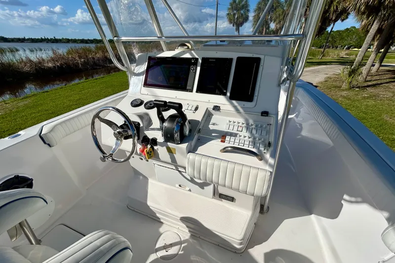 Slide: The Image of 2003 Donzi 32 ZF Open boat cockpit with steering wheel and control panel. - 22