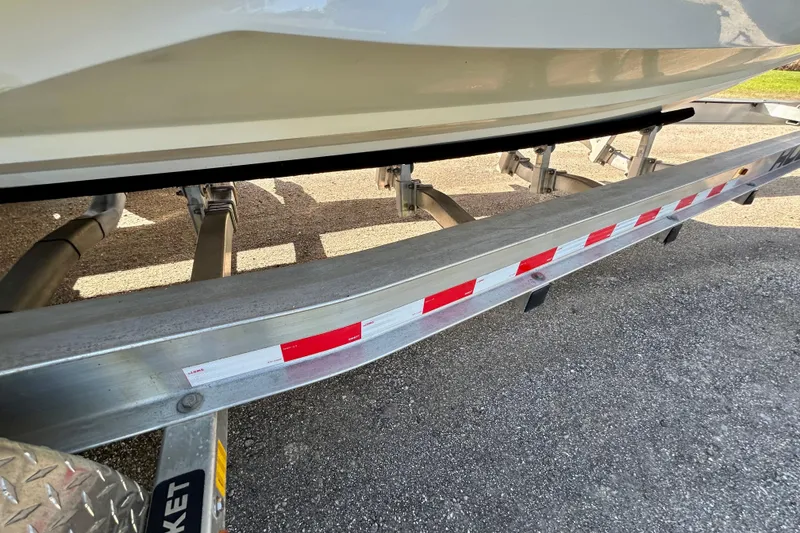 Slide: The Image of Trailer supporting a 2003 Donzi 32 ZF Open boat, showing undercarriage details. - 26