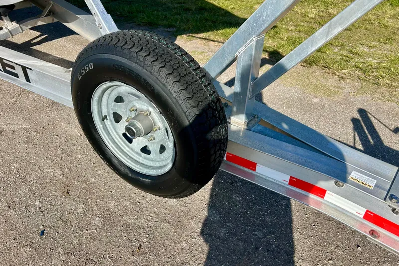 Slide: The Image of Trailer wheel for 2003 Donzi 32 ZF Open boat on pavement. - 27