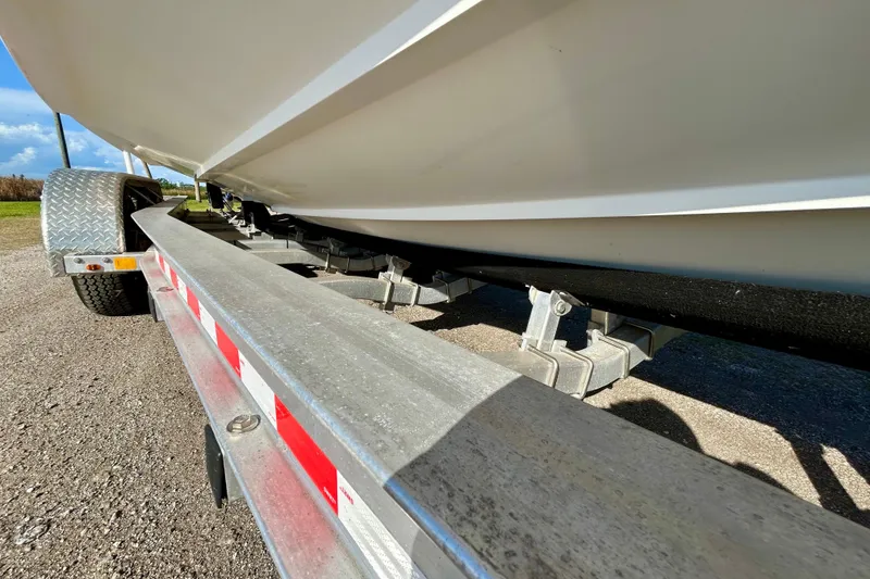 Slide: The Image of Trailer carrying a 2003 Donzi 32 ZF Open boat, showcasing its underside and trailer details. - 28