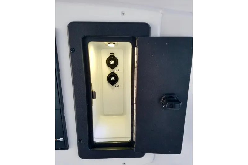 Slide: The Image of 2003 Donzi 32 ZF Open boat compartment with USB and ACC ports. - 32