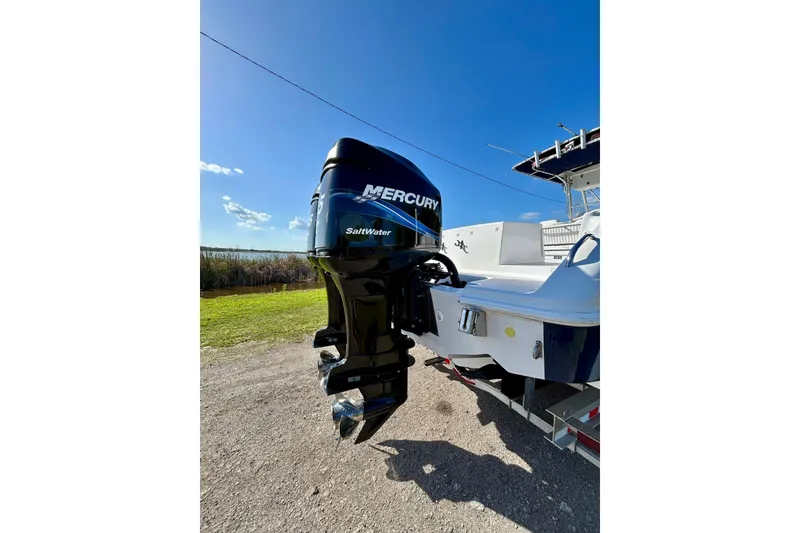 Slide: The Image of 2003 Donzi 32 ZF Open boat with Mercury Saltwater outboard motor, parked on a sunny day. - 4