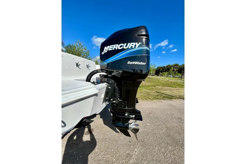 Slide: The Image of Mercury Saltwater outboard motor on 2003 Donzi 32 ZF Open boat, sunny day. - 5