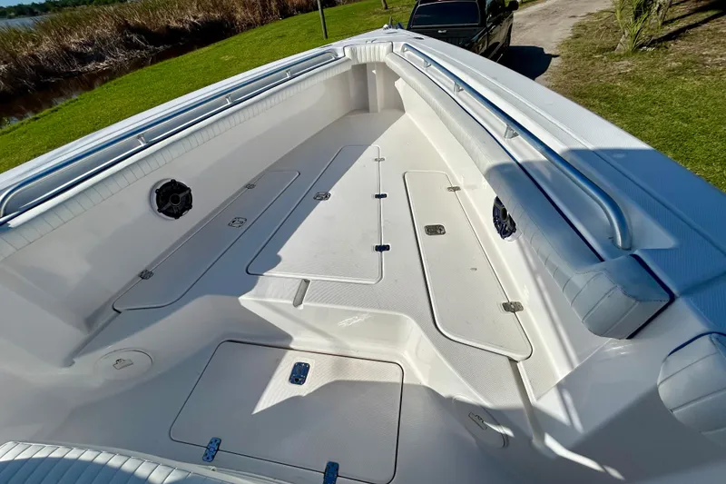 Slide: The Image of 2003 Donzi 32 ZF Open boat interior with white seating and storage compartments. - 7