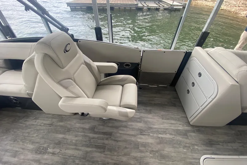 Slide: The Image of 2021 Crest Caribbean Platinum 230 SLC boat interior with luxurious seating and storage. - 10