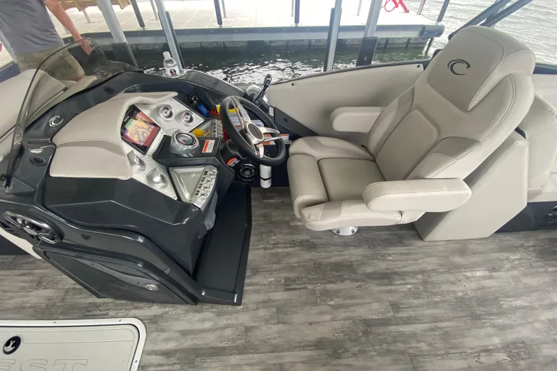 Slide: The Image of Helm of 2021 Crest Caribbean Platinum 230 SLC boat with modern controls and seating. - 11