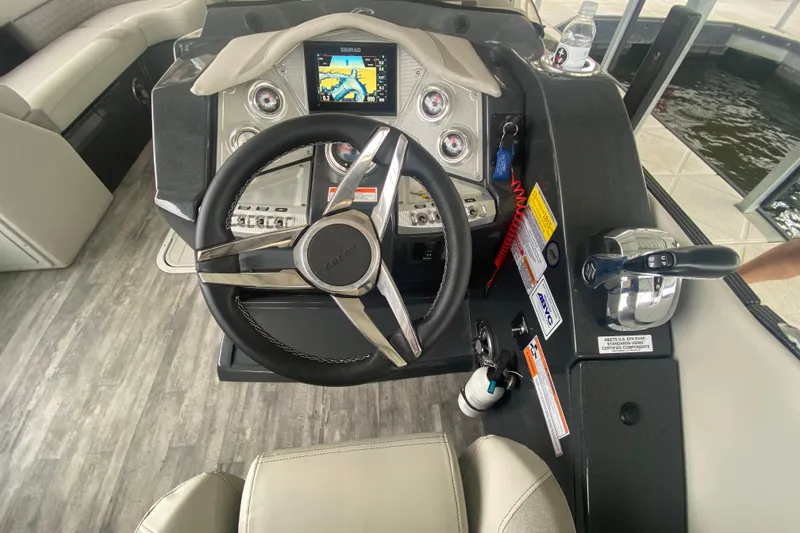 Slide: The Image of Steering console of 2021 Crest Caribbean Platinum 230 SLC boat with navigation display. - 12