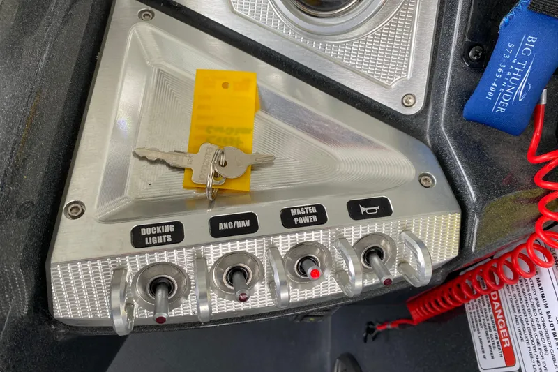 Slide: The Image of Control panel of 2021 Crest Caribbean Platinum 230 SLC with keys and switches. - 15