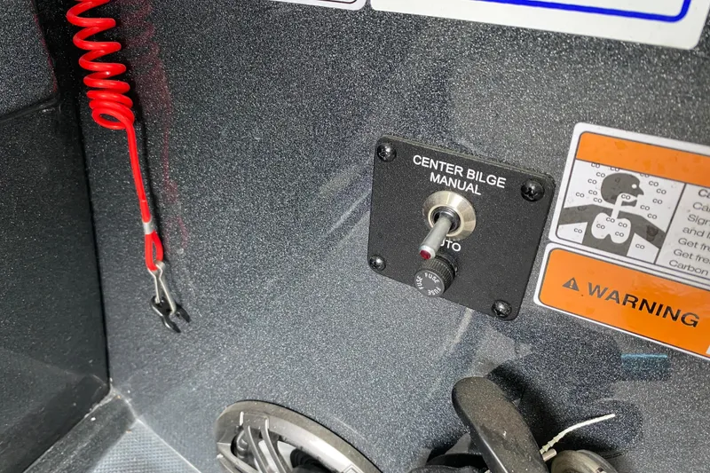 Slide: The Image of Control panel of 2021 Crest Caribbean Platinum 230 SLC with bilge switch and warning labels. - 17