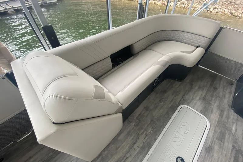 Slide: The Image of Luxurious seating on 2021 Crest Caribbean Platinum 230 SLC pontoon boat interior. - 21