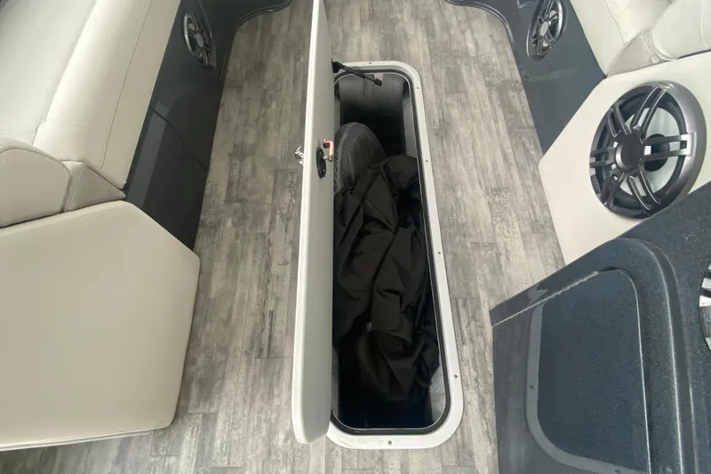 Slide: The Image of 2021 Crest Caribbean Platinum 230 SLC boat interior with open storage compartment. - 23