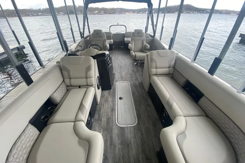 Slide: The Image of Luxurious interior of 2021 Crest Caribbean Platinum 230 SLC pontoon boat on a serene lake. - 25