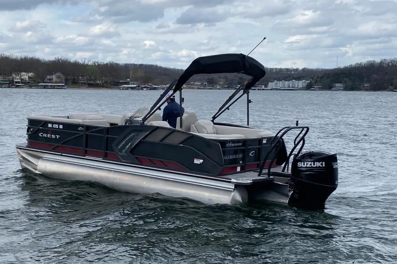 Slide: The Image of 2021 Crest Caribbean Platinum 230 SLC pontoon boat on a lake with Suzuki outboard motor. - 3