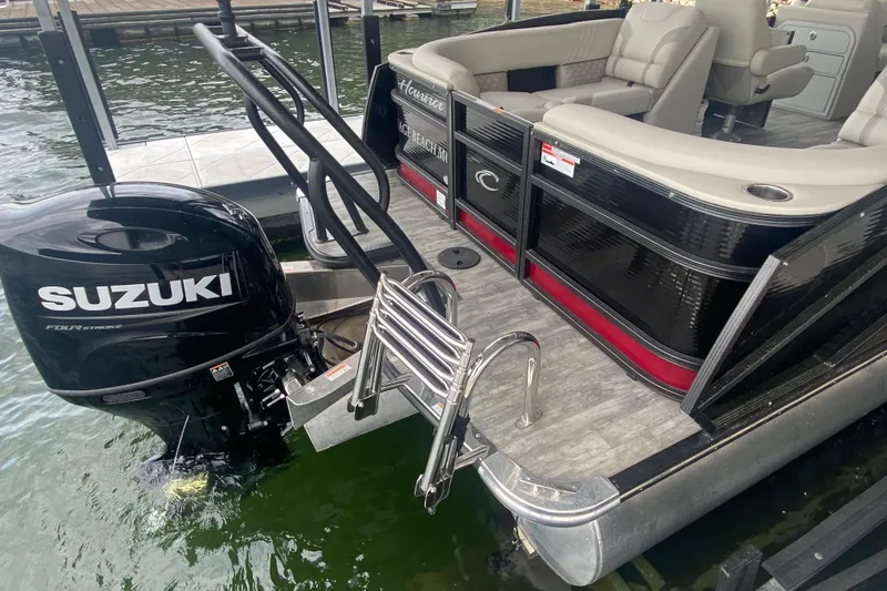 Slide: The Image of 2021 Crest Caribbean Platinum 230 SLC pontoon boat with Suzuki outboard motor and swim ladder. - 7