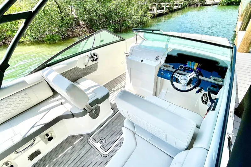 Slide: The Image of 2024 Sea Ray SDX 250 Outboard boat interior with sleek seating and modern dashboard. - 11