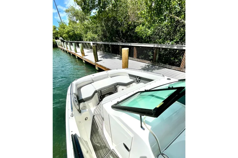 Slide: The Image of 2024 Sea Ray SDX 250 Outboard docked by a scenic wooden pier. - 13