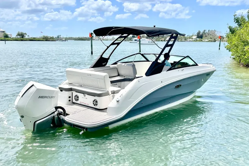 Slide: The Image of 2024 Sea Ray SDX 250 Outboard boat on calm water under a clear sky. - 2