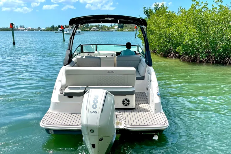 Slide: The Image of 2024 Sea Ray SDX 250 Outboard cruising in clear blue waters. - 4