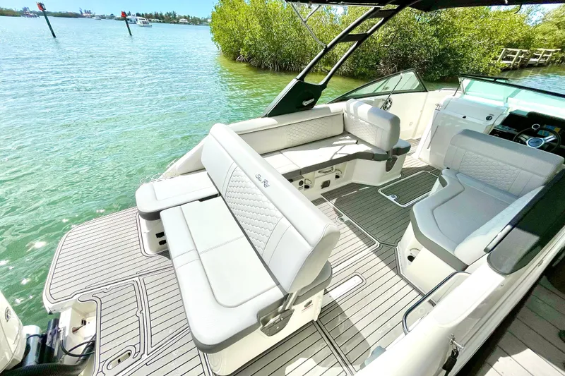 Slide: The Image of 2024 Sea Ray SDX 250 Outboard boat interior with luxurious seating and scenic water view. - 6